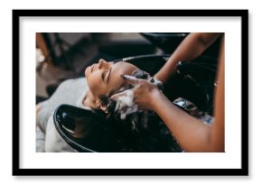 Beautiful young woman getting a hair wash. Hair salon styling concept.