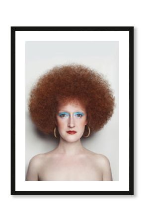 Vintage style portrait of young beautiful woman with fancy makeup and afro hair