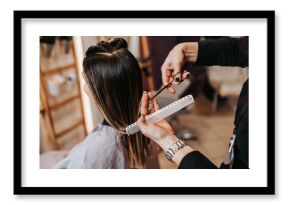 Beautiful young woman getting her haircut by a hairstylist at a beauty salon.