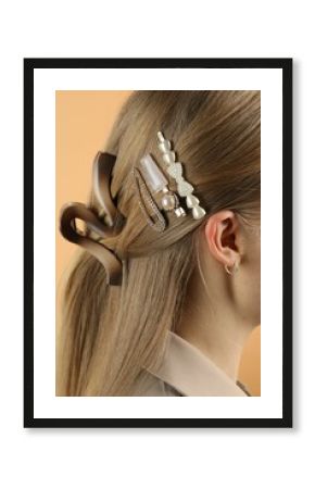 Woman with beautiful hair clips on beige background, closeup