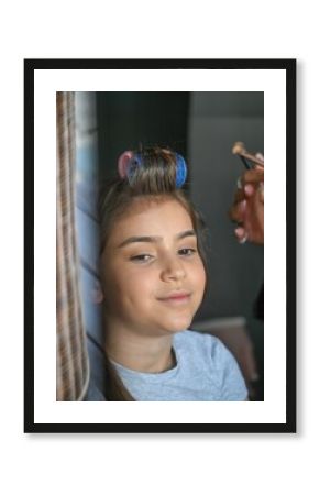 High resolution image of a single beautiful twelve year old Caucasian girl photo shot getting makeup and hair done