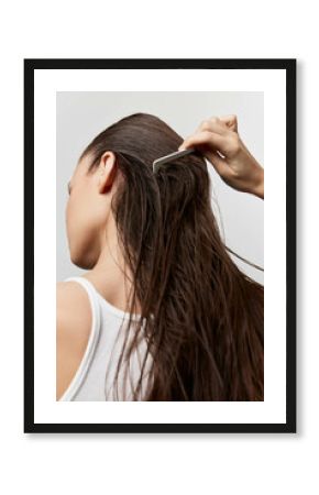 Hair care, grooming, beauty routine, woman combing wet hair, close up shot, natural hair texture, neutral background