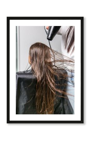 Adorable Little Girl Enjoying Her First Haircut in a Beauty Salon.