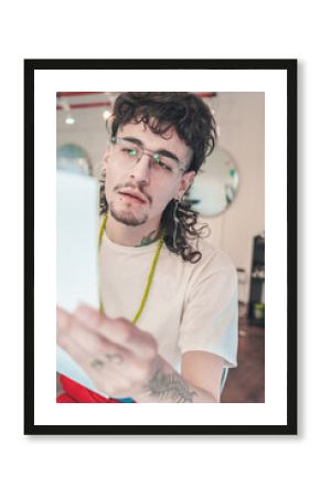Young stylish man reading instructions in a hair salon