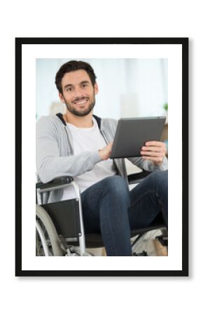 happy freelancer in the wheelchair holding a tablet