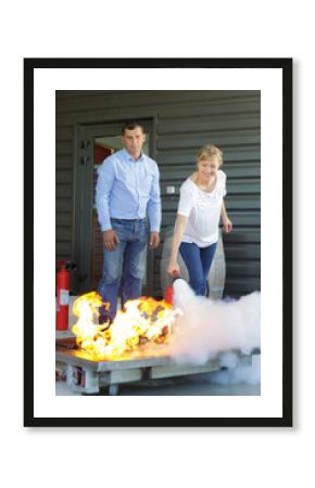 woman demonstrating how to use a fire extinguisher