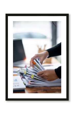 Business Documents concept,  woman hands working on Stacks paper files for checking document achieves on folders papers at  office.