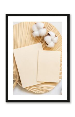 Blank cards on dried palm leaf with cotton flowers top view, wedding mockup