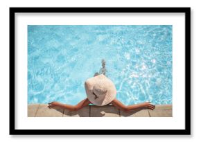 Young woman relaxing in the swimming pool with copy space