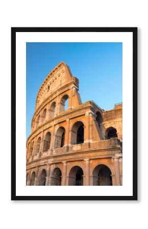Vertical view to wall with arch of colosseum with blue sky in Rome in Italy