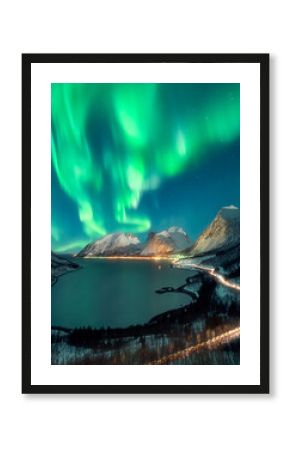 Northern lights over snow covered fjord in Norway