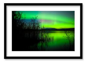 Northern lights mirrored on lake