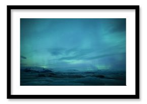 Northern lights above lagoon in Iceland