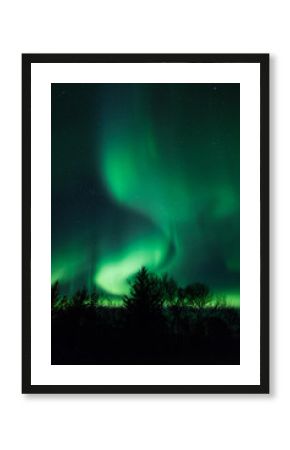 Northern lights above lagoon in Iceland