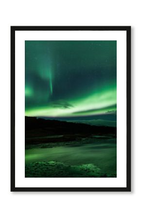 Northern lights above lagoon in Iceland