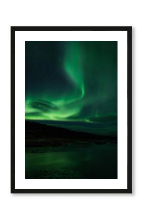 Northern lights above lagoon in Iceland