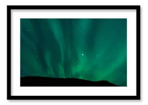 Northern lights above lagoon in Iceland