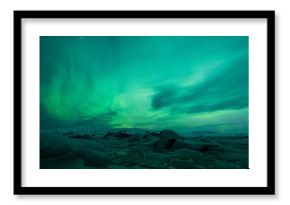 Northern lights above lagoon in Iceland