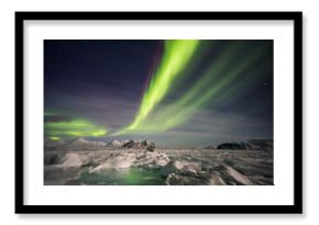 Beautiful Northern Lights over the Arctic frozen fjord