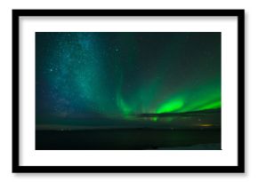 Beautiful and breathtaking view of Aurora Borealis (northern lights) and Milky way on the winter night sky in Vatnsnes peninsula, east Iceland