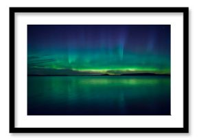 Northern lights dancing over calm lake in Farnebofjarden national park in Sweden.