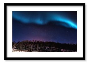 Northern lights (aurora borealis) in Lofoten islands, Norway. Night winter landscape with polar lights and beautiful starry sky