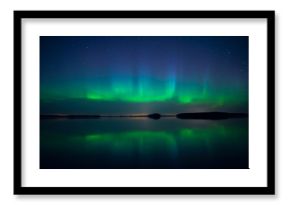 Northern lights dancing over calm lake. Farnebofjarden national park in Sweden