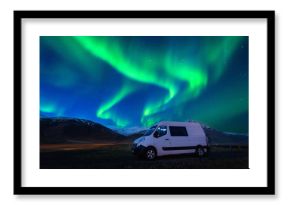 Northern lights (Aurora borealis) and car at night.