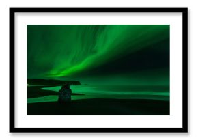 The Northern Light at the Vik Cliffs Iceland. Landscape of Vik beach, with green bands of Aurora Borealis. Night Seascape a paradise for travel and vacations.