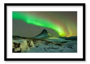 Aurora Borealis the Northern Light at Kirkjufell Iceland. scenic view of waterfall Kirkjufellsfoss aurora polaris in background.Snaefellnes, Iceland