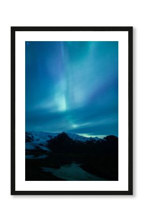 Northern lights above lagoon in Iceland