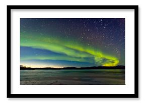 Northern Lights and morning dawn over frozen lake