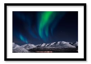 Northern lights above fjords in northern Norway.