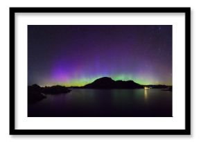 panoramic view of colorful northern lights (Aurora Borealis) at fjord landscape, Norway, Europe  