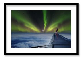 Aerial view of Northern Lights (Aurora Borealis) from window of an flying airplane