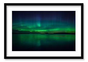 Northern lights dancing over calm lake in Farnebofjarden national park in Sweden