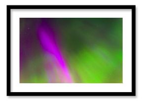 Polar lights Aurora Borealis in the night starry sky, texture and purple and green colored natural phenomena.