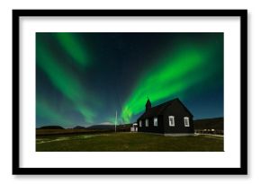 Northern Lights over The Black Church Budir, Iceland. Aurora Borealis in an amazing nightscape. Travel destination with beautiful green lights landscape.