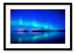 Northern lights dancing over calm lake. Farnebofjarden national park in Sweden