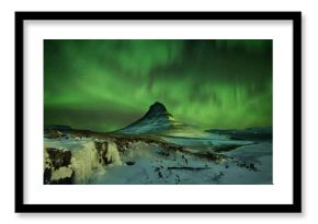 Aurora Borealis the Northern Light at Kirkjufell Iceland. scenic view of waterfall Kirkjufellsfoss aurora polaris in background.Snaefellnes, Iceland