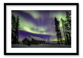 Beautiful Northern Lights (Aurora Borealis) in the night sky over winter Lapland landscape, Finland, Scandinavia