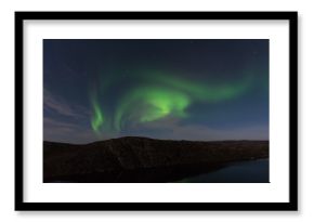 Northern lights, aurora in autumn over the lake.