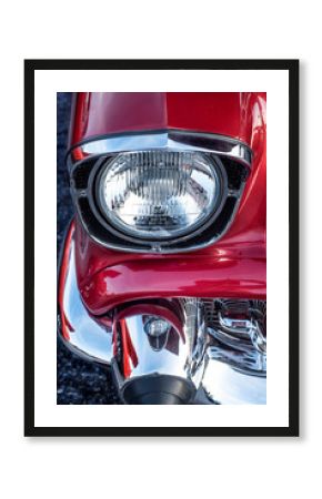 Closeup chrome headlight red classic 1950s nostalgic hot rod muscle car at car show