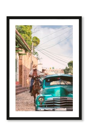 Cuba classic car with horse rider