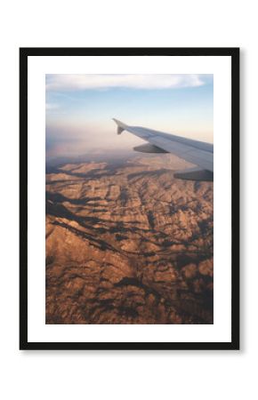 Vertical view of a canyon natural landscape from an airplane window