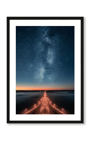 Epic view of highway at night with beautiful stars and milky way in the sky. Transportation background.