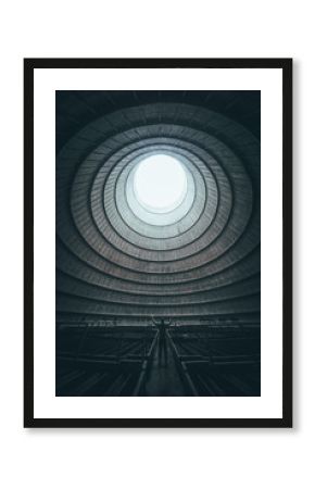 Figure standing inside abandoned cooling tower