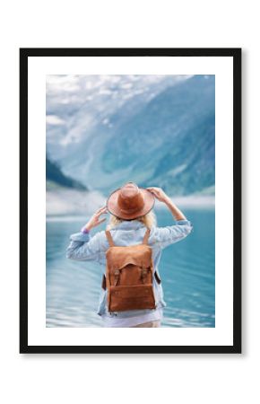 Travel image. Traveler look on the mountain lake. Travel and active life concept. Adventure and travel in the mountains region in the Austria.