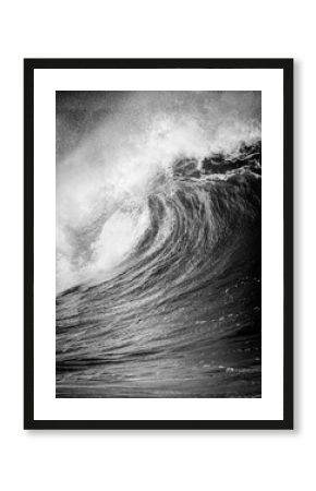 Big breaking Ocean wave in black and white at Waimea bay on the north shore of Oahu Hawaii