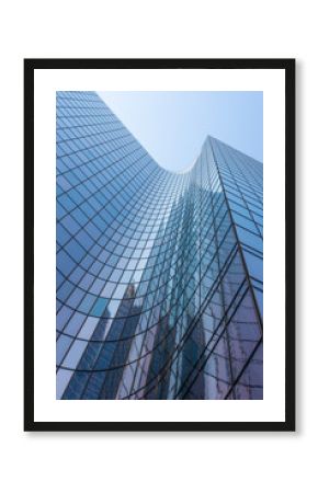 Blue glass skyscraper facade reflections against sky